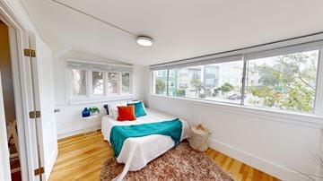 San Francisco apartment for rent - A bedroom with a bed, pillows, and a rug.