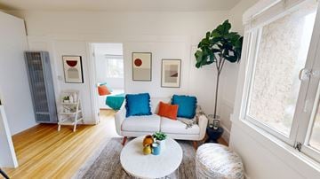 San Francisco apartment for rent - A living room with a white couch and a round table.