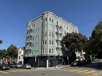 San Francisco apartment for rent - A street view of a tall building with a fire escape on the side.