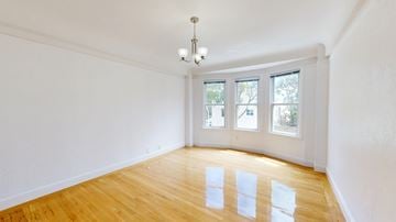 San Francisco apartment for rent - A room with wooden floors and a chandelier.