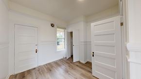 San Francisco apartment for rent - A hallway with white doors and wooden floors.