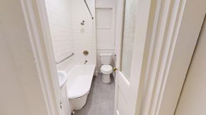 San Francisco apartment for rent - A white toilet is in a small bathroom with a white tub and shower.
