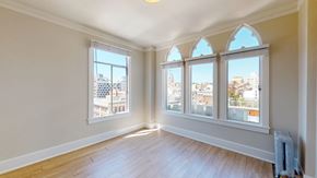 San Francisco apartment for rent - A room with a large window and wooden flooring.
