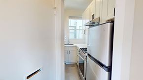 San Francisco apartment for rent - A kitchen with a refrigerator and a stove top oven.