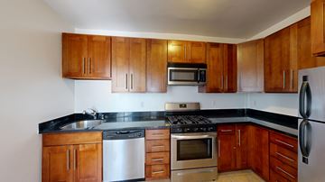 San Francisco apartment for rent - A kitchen with wooden cabinets and stainless steel appliances.