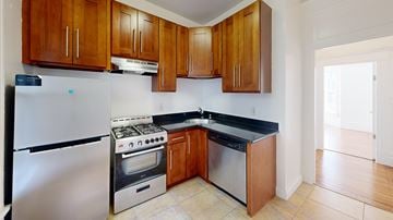 San Francisco apartment for rent - A kitchen with wooden cabinets and stainless steel appliances.