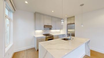 San Francisco apartment for rent - A kitchen with a marble countertop and stainless steel appliances.
