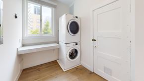 San Francisco apartment for rent - A white washer and dryer in a small room with a window.