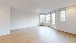 San Francisco apartment for rent - A large empty room with wooden floors and white walls.