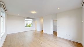 San Francisco apartment for rent - A large empty room with wooden floors and white walls.