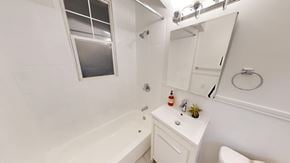 San Francisco apartment for rent - A white bathroom with a tub, toilet, and sink.
