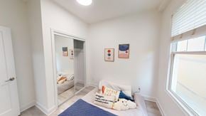 San Francisco apartment for rent - A bedroom with a bed, pillow, and two pictures on the wall.