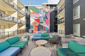 Berkeley apartment for rent - Vibrant courtyard with a large mural, furnished with variety of seating options