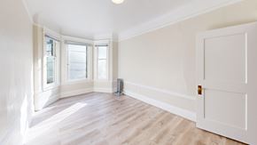 San Francisco apartment for rent - A room with a white door, a window, and a radiator on the floor.