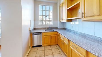 San Francisco apartment for rent - A kitchen with wooden cabinets and a granite countertop.