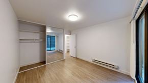 San Francisco apartment for rent - A room with a wooden floor and a white wall with a mirror on the wall.