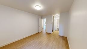 San Francisco apartment for rent - A long hallway with a light on the ceiling and doors on the right.