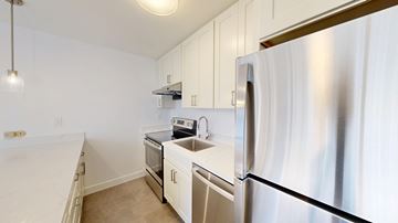 San Francisco apartment for rent - A kitchen with white appliances and cabinets.