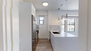 San Francisco apartment for rent - A kitchen with a white counter top and a window.