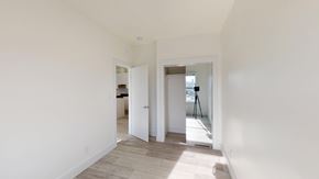 San Francisco apartment for rent - A room with white walls and wooden flooring, with a doorway leading to another room.