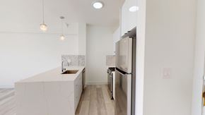San Francisco apartment for rent - A kitchen with a sink, refrigerator, and a counter.