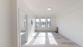 San Francisco apartment for rent - A spacious room with a long hallway leading to a window.
