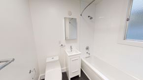 San Francisco apartment for rent - A white bathroom with a toilet, sink, and bathtub.