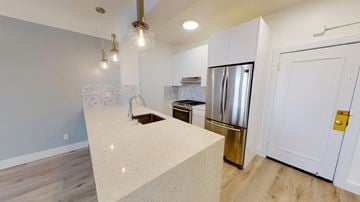 San Francisco apartment for rent - A kitchen with a stainless steel refrigerator and a white countertop.