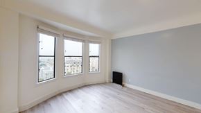 San Francisco apartment for rent - A room with a window overlooking a cityscape.