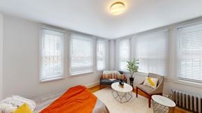 San Francisco apartment for rent - A bright room with a bed, a chair, and a table.