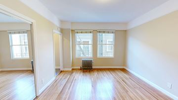 San Francisco apartment for rent - A room with wooden floors and a radiator.
