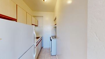 San Francisco apartment for rent - A white refrigerator is in a kitchen with white walls.