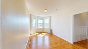 San Francisco apartment for rent - A room with wooden floors and white walls.