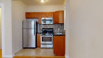 San Francisco apartment for rent - A kitchen with a stainless steel refrigerator, oven, and microwave.