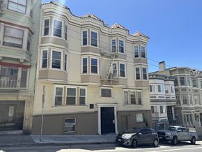 San Francisco apartment for rent - A row of multi-story buildings with cars parked in front.