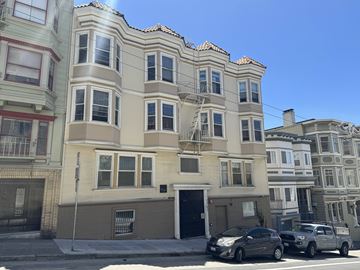 San Francisco apartment for rent - A row of multi-story buildings with cars parked in front.