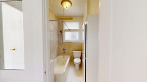 San Francisco apartment for rent - A white bathroom with a tub, toilet and sink.