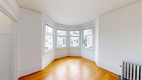 San Francisco apartment for rent - A room with a wooden floor and white walls.