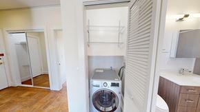 San Francisco apartment for rent - A washing machine is built into a wall in a laundry room.
