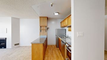 San Francisco apartment for rent - A kitchen with wooden cabinets and a refrigerator.