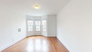 San Francisco apartment for rent - A room with wooden floors and white walls.