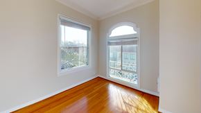 San Francisco apartment for rent - A room with wooden floors and a balcony with a railing.