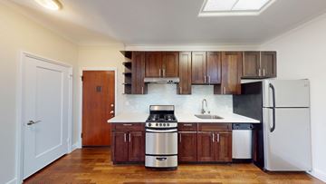San Francisco apartment for rent - A kitchen with wooden cabinets and stainless steel appliances.