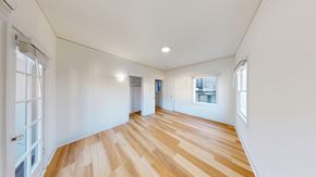 Berkeley apartment for rent - A room with wooden floors and white walls.