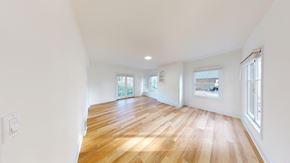 Berkeley apartment for rent - A room with wooden floors and white walls.
