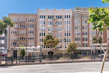 San Francisco apartment for rent - A large, multi-story building with a fence in front of it.