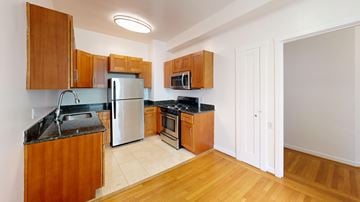 San Francisco apartment for rent - A kitchen with wooden cabinets and a white refrigerator.