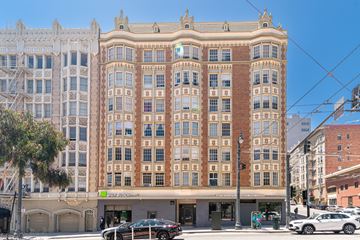 San Francisco apartment for rent - A large, multi-story building with a sign that reads "HIGH ALT" in front of it.