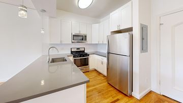 San Francisco apartment for rent - A kitchen with a stainless steel refrigerator and a grey counter top.