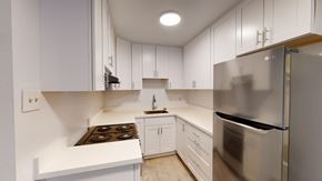 Berkeley apartment for rent - A modern kitchen with white cabinets and stainless steel appliances.